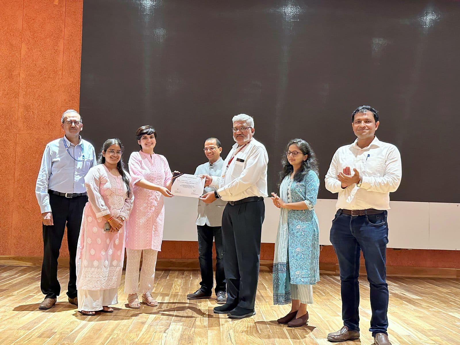 Certificates being presented on stage