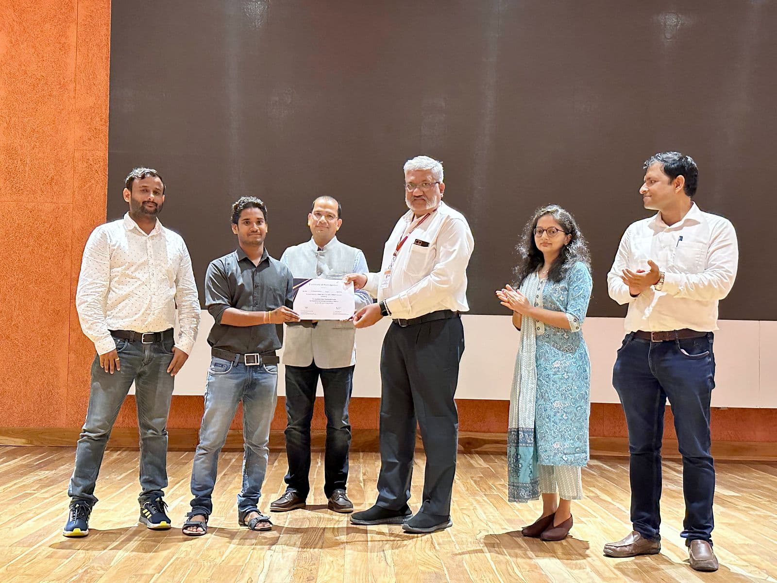 Certificates being presented on stage