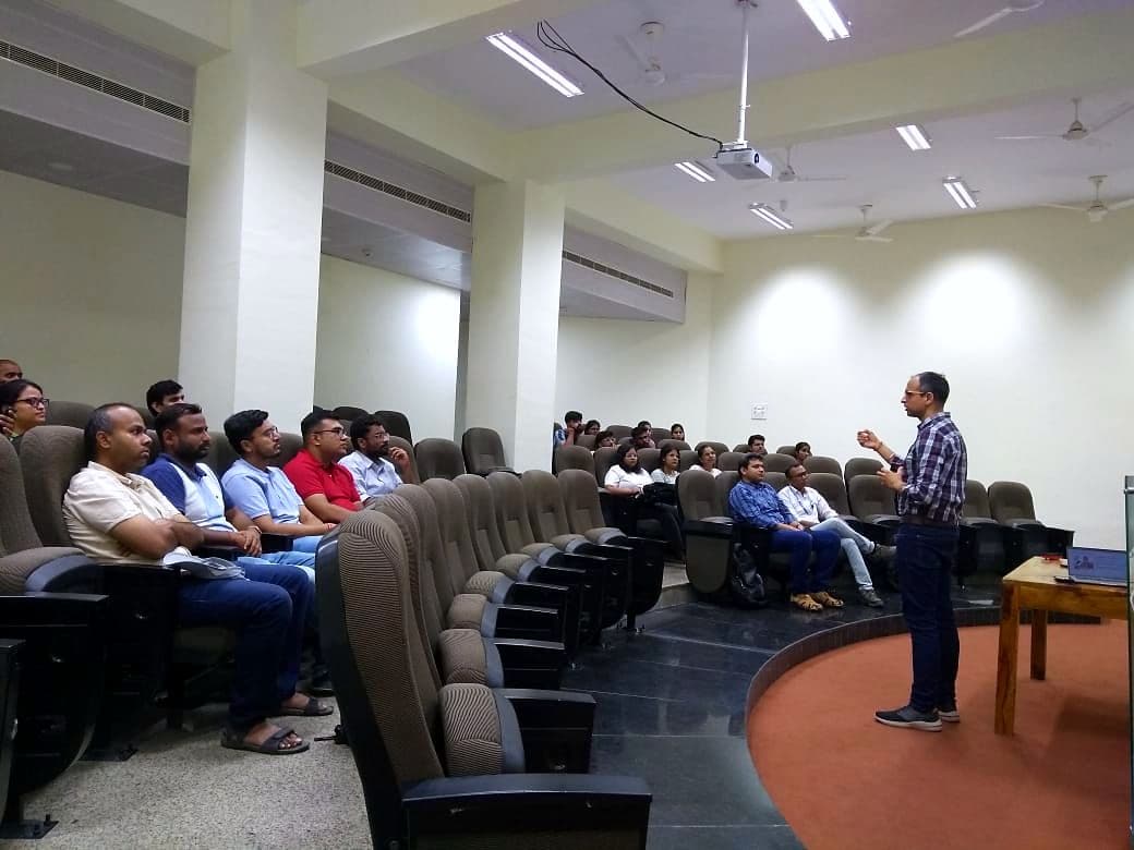 Speaker presenting to an audience in a lecture theatre