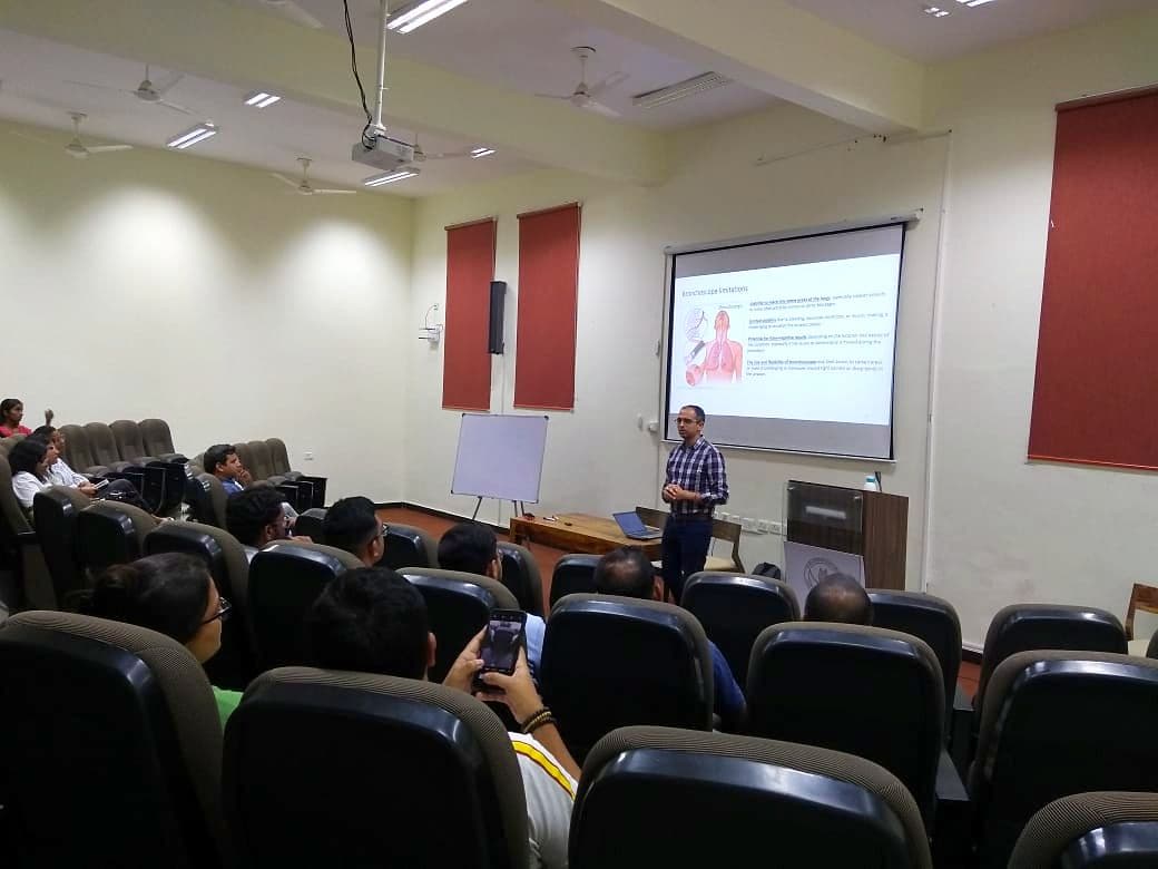 Speaker presenting to an audience in a lecture theatre