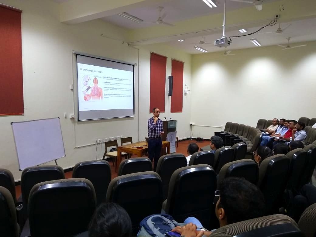 Speaker presenting to an audience in a lecture theatre