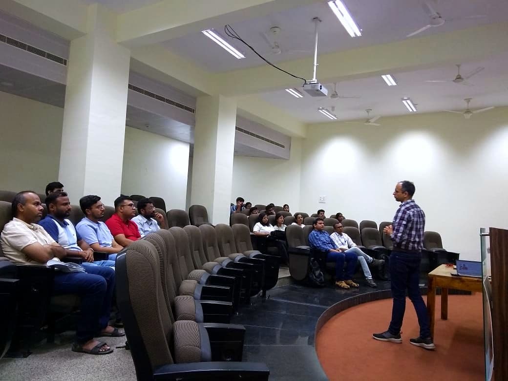 Speaker presenting to an audience in a lecture theatre
