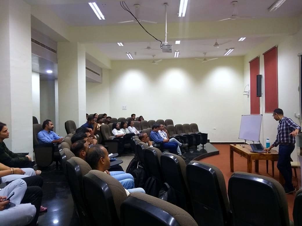 Speaker presenting to an audience in a lecture theatre