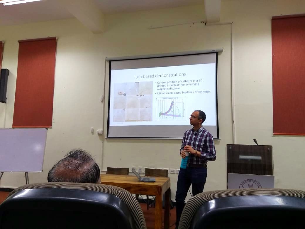 Speaker presenting to an audience in a lecture theatre