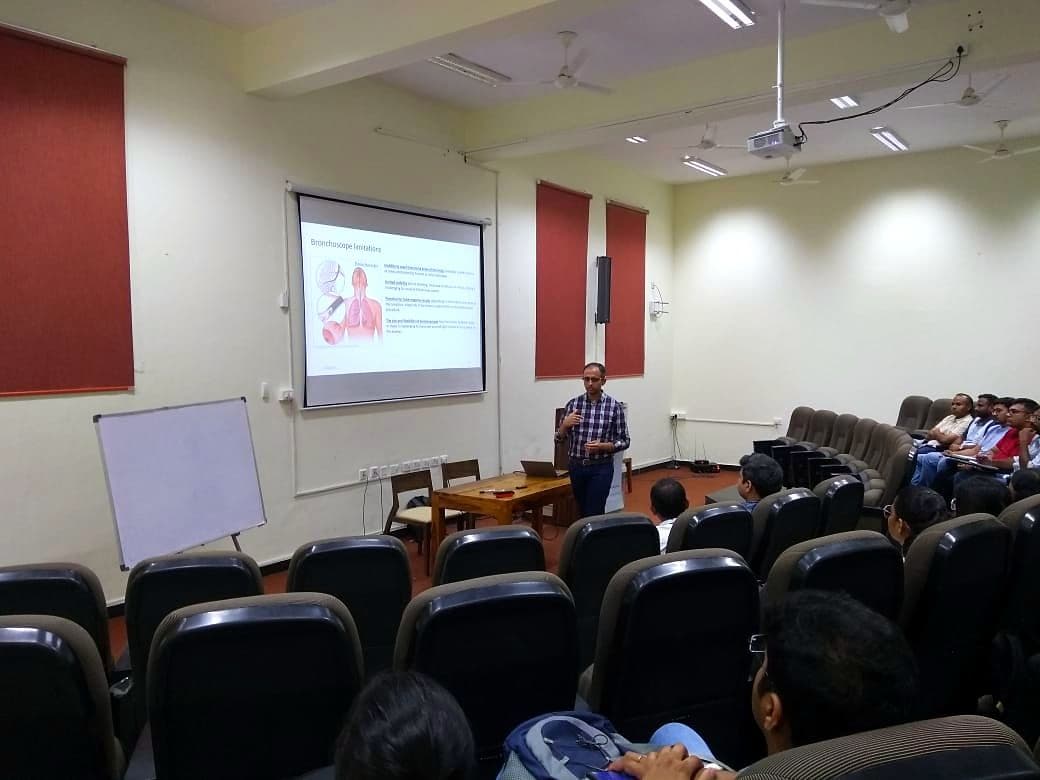 Speaker presenting to an audience in a lecture theatre