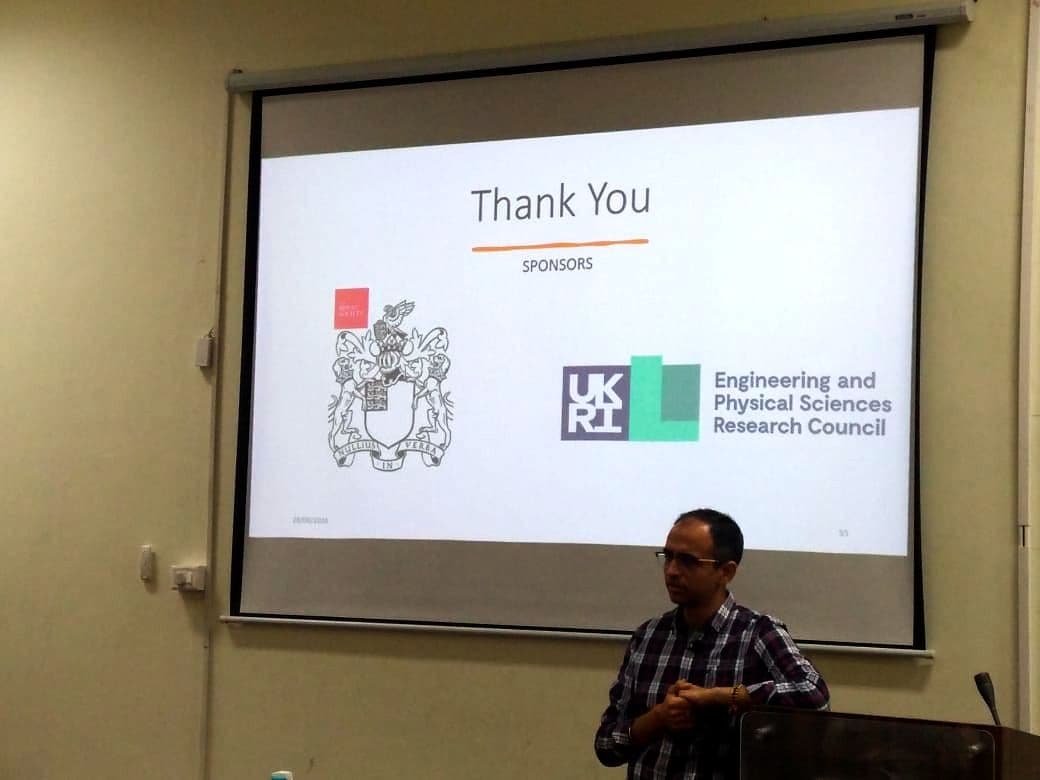 Speaker presenting to an audience in a lecture theatre