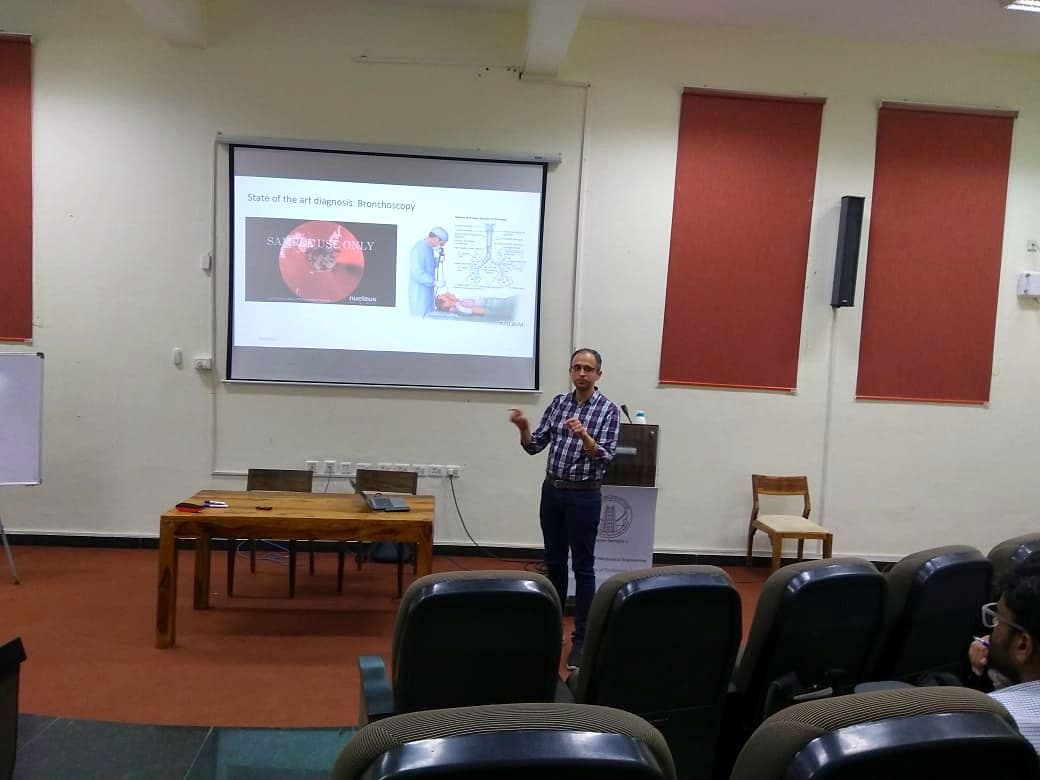 Speaker presenting to an audience in a lecture theatre