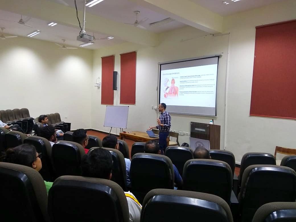 Speaker presenting to an audience in a lecture theatre