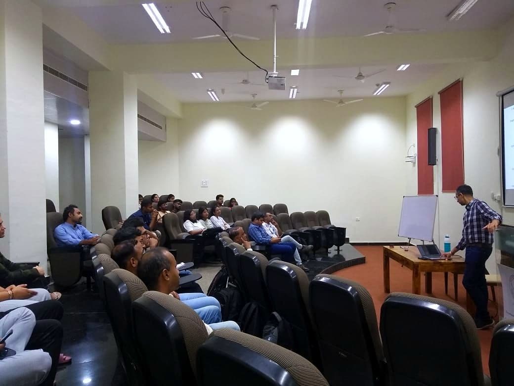 Speaker presenting to an audience in a lecture theatre