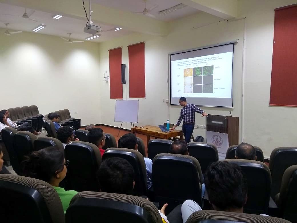 Speaker presenting to an audience in a lecture theatre
