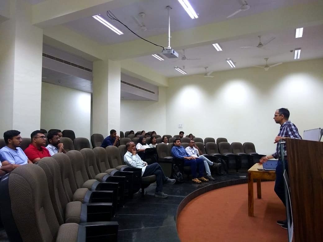 Speaker presenting to an audience in a lecture theatre