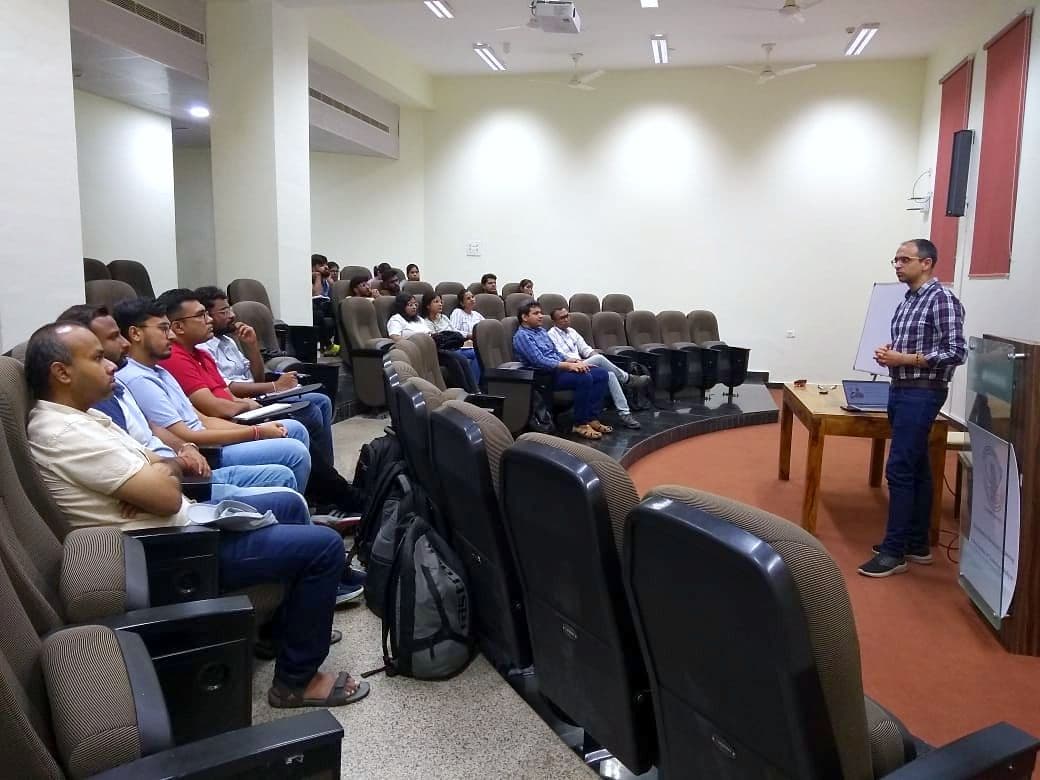 Speaker presenting to an audience in a lecture theatre