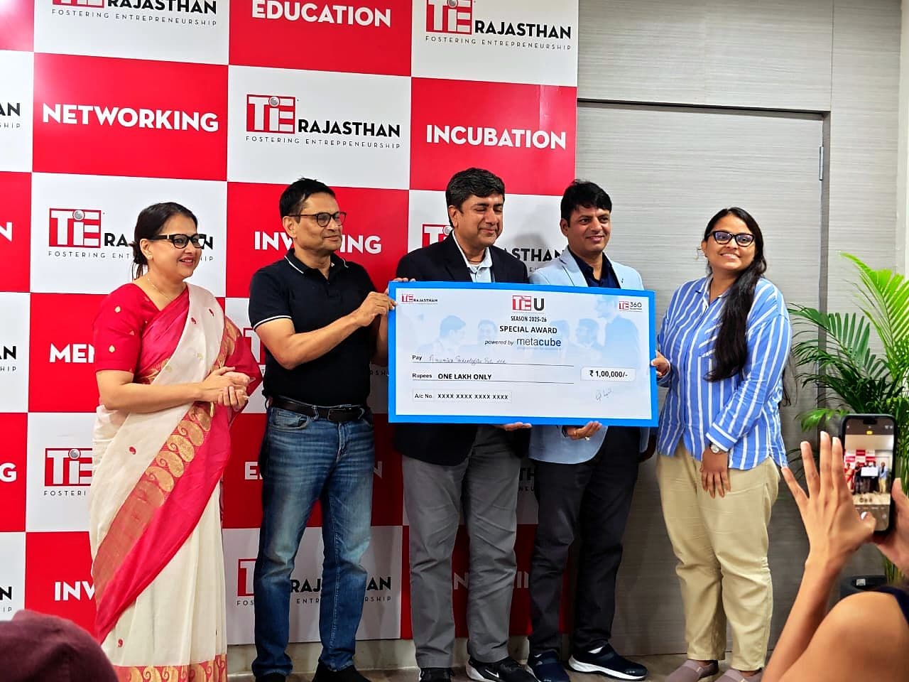 Cheque presentation at a TiE Rajasthan event