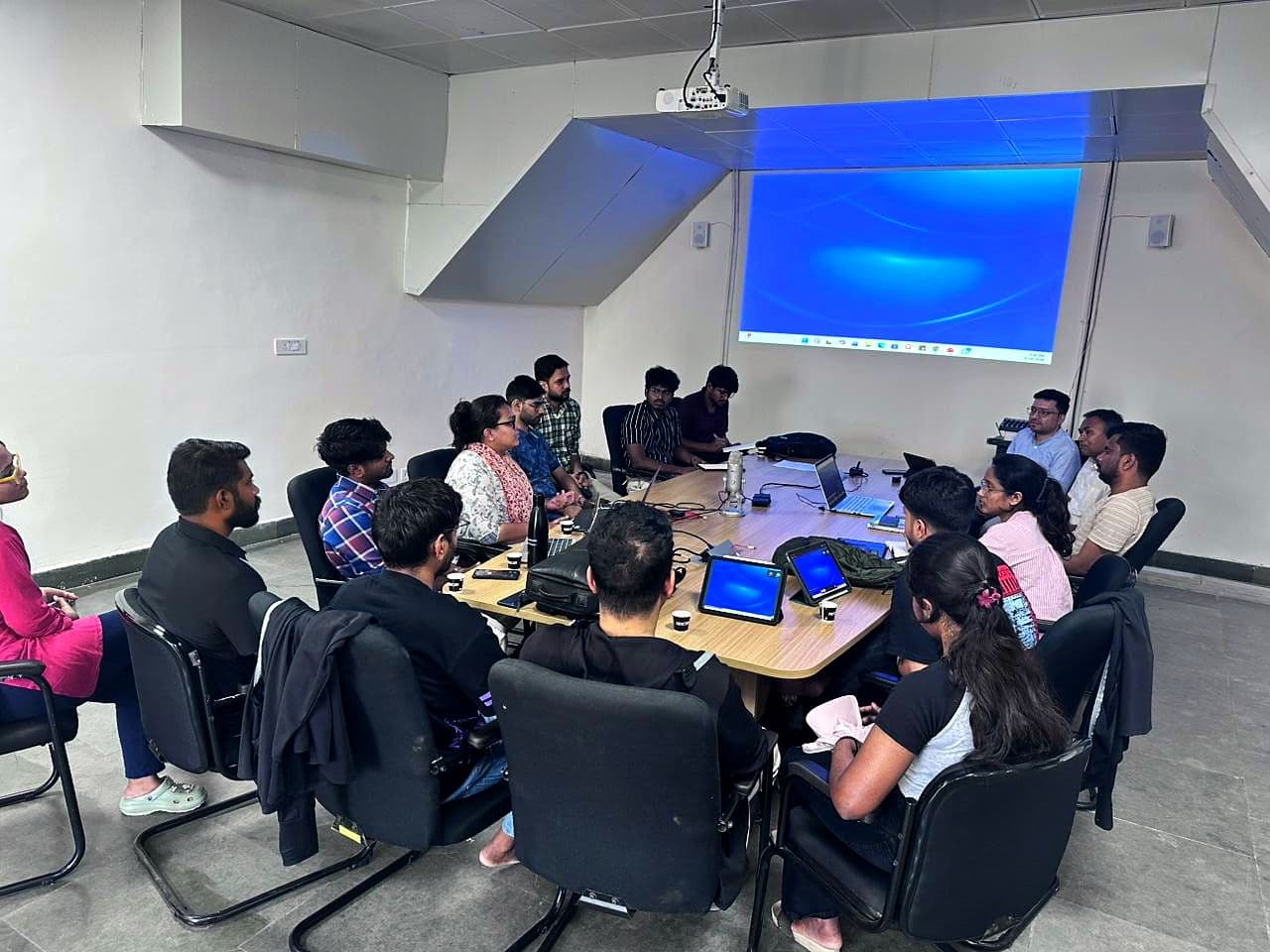 Participants working around tables during a session