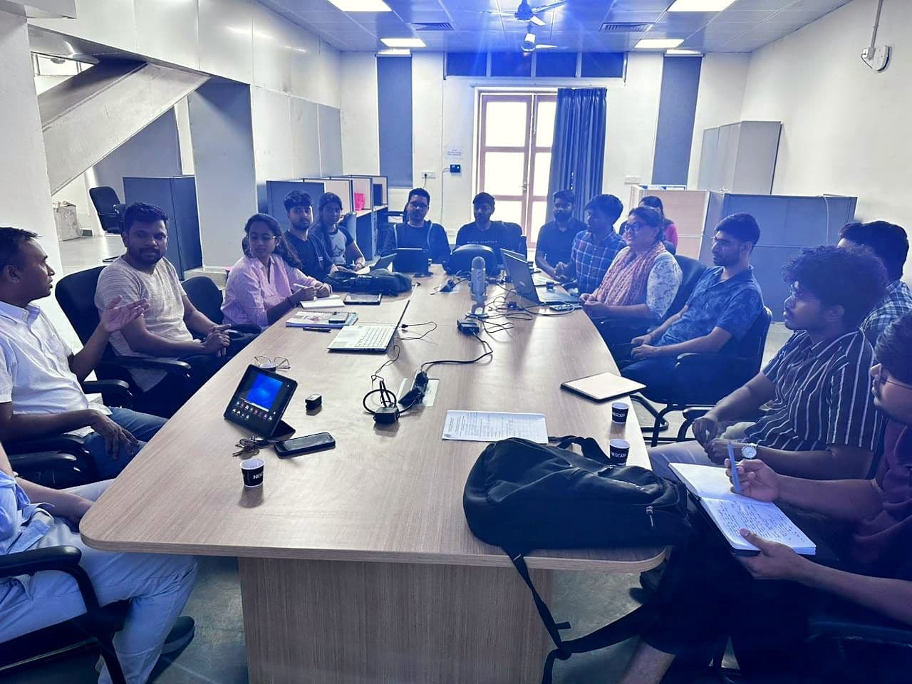 Participants working around tables during a session