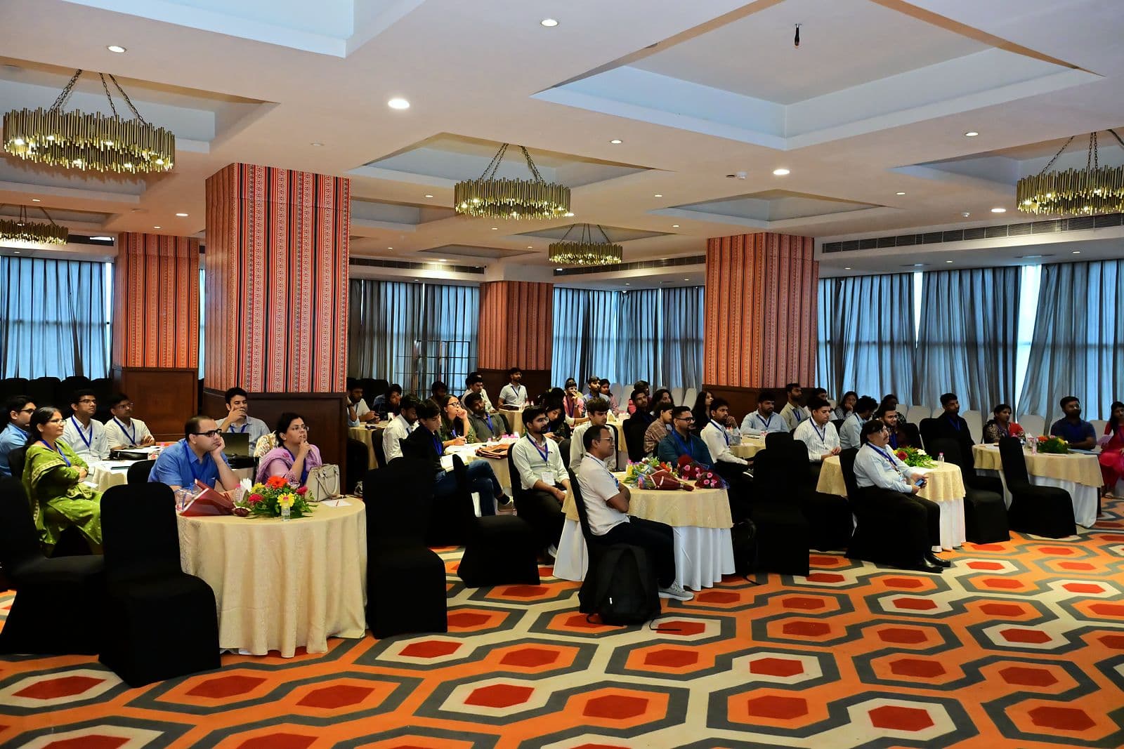 Audience seated at tables in an event hall