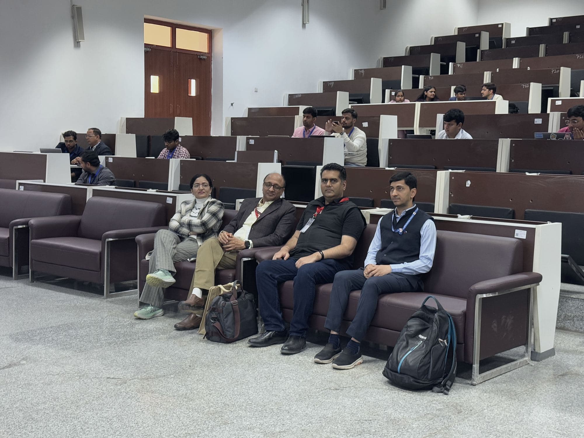 Delegates seated in a lecture hall during a session