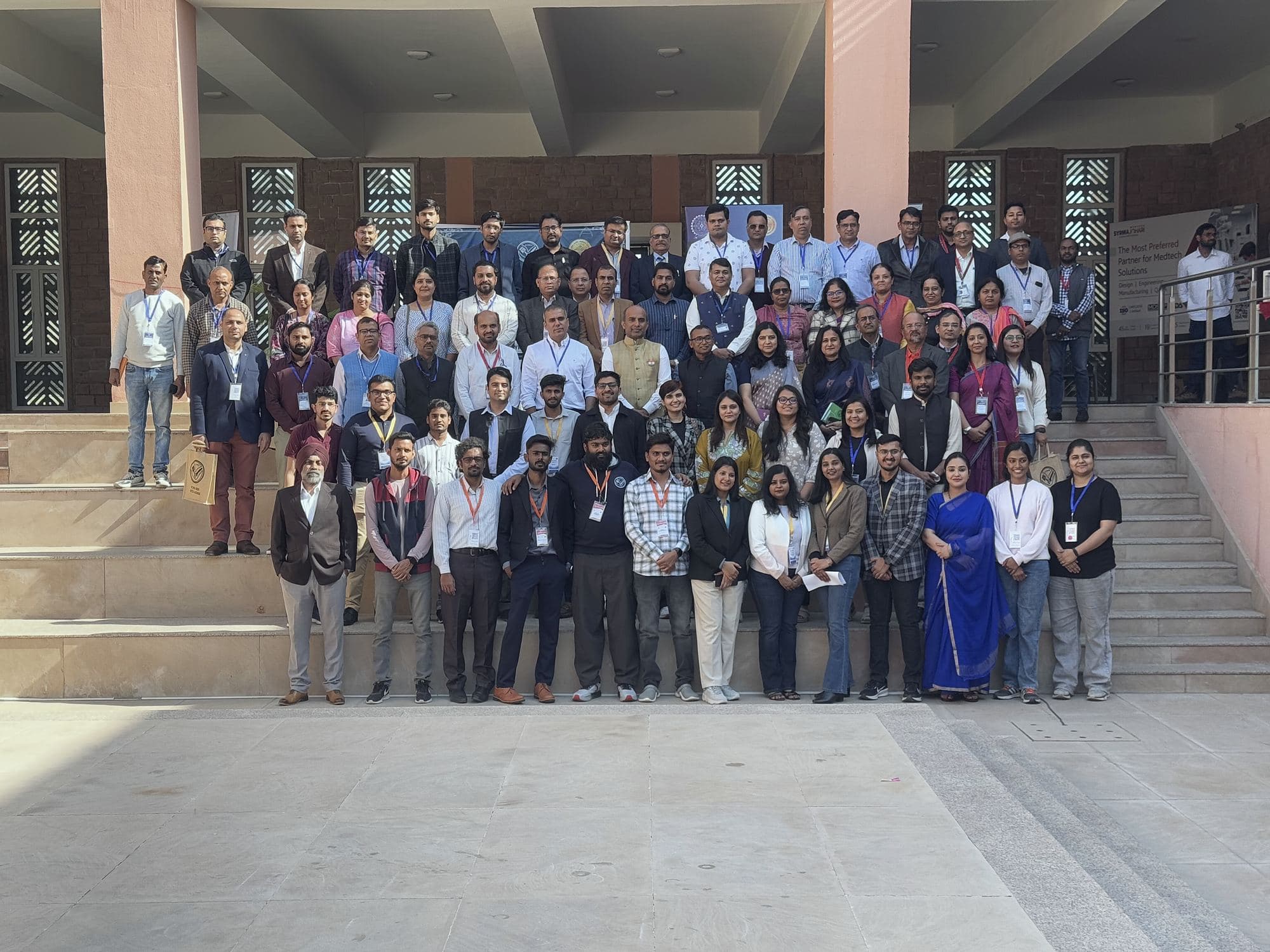 Large group photograph of conference delegates and participants on building steps